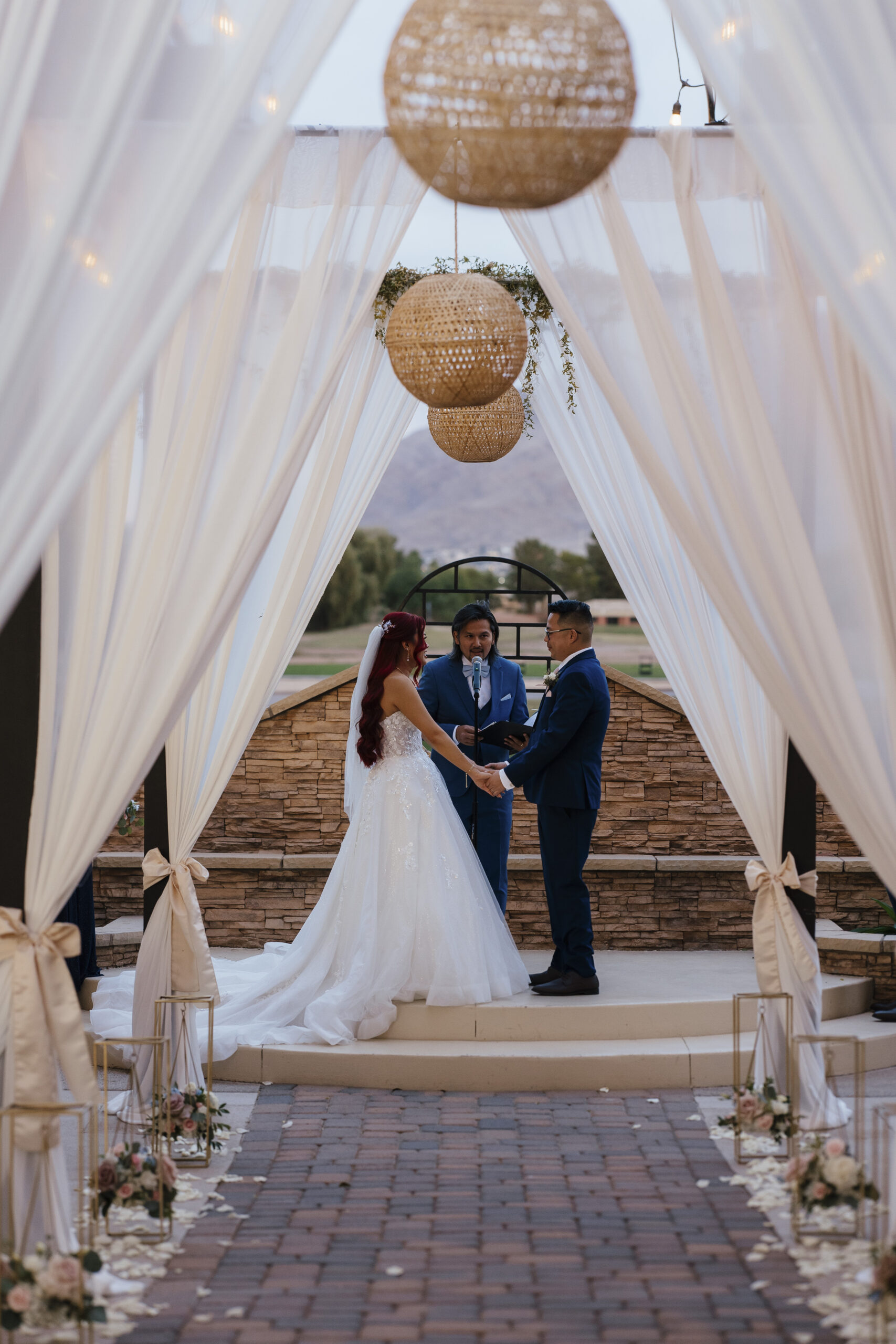 Bride and groom exchanging vows during an outdoor wedding ceremony at Stallion Mountain Golf Course in Las Vegas, captured by a Las Vegas wedding photographer.