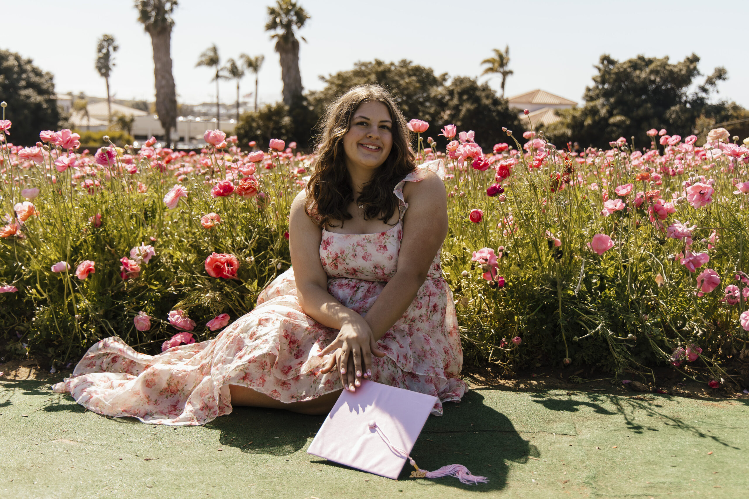 Graduation portrait photography of Maddie at The Flower Fields in Carlsbad, California, captured during a travel portrait session celebrating her milestone.