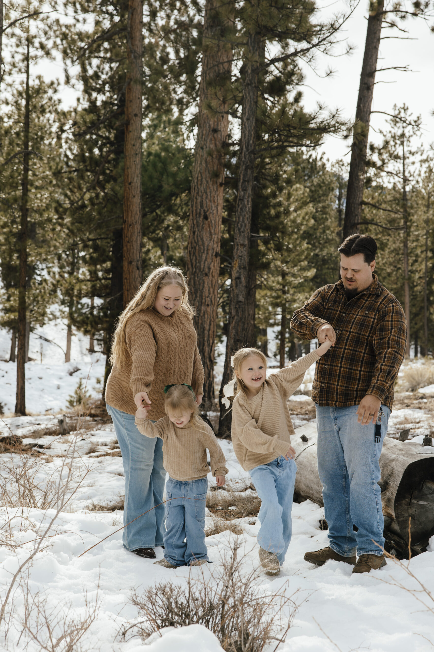 Winter family portrait photography of The Carson family playing in the snow at Mount Charleston after a fresh snowfall, captured near Las Vegas.